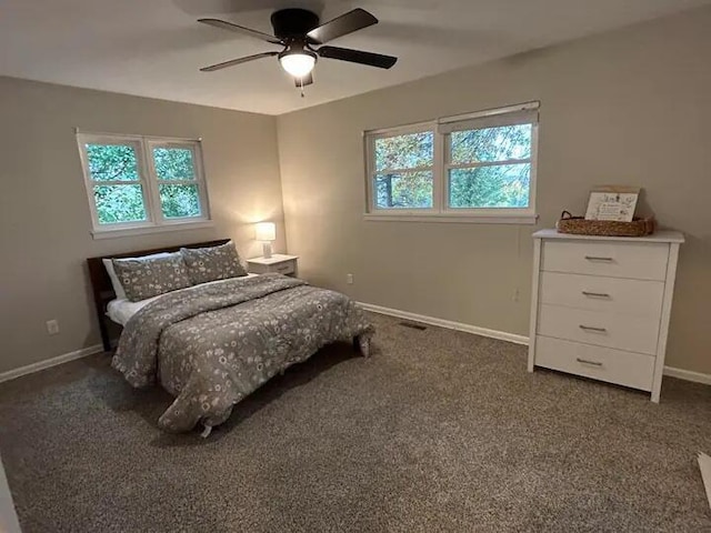 carpeted bedroom with baseboards and a ceiling fan