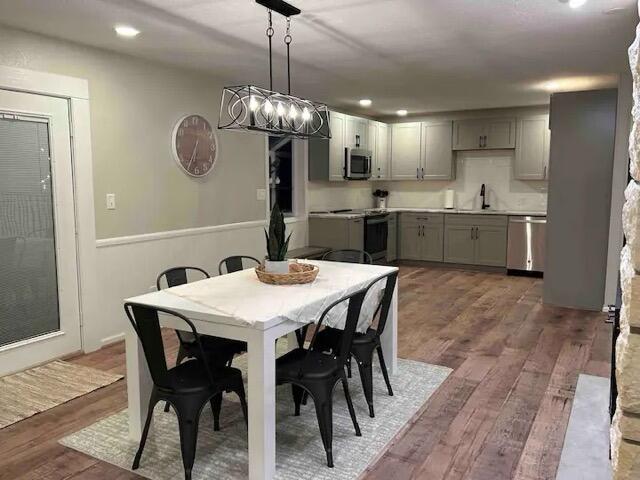 dining space with recessed lighting and wood finished floors