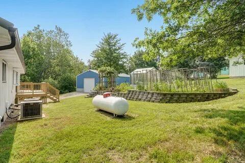 view of yard featuring cooling unit and an outbuilding