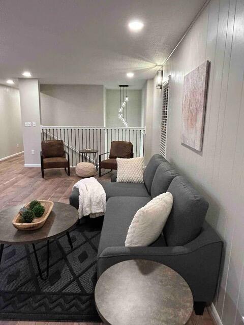 living area featuring baseboards and wood finished floors