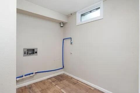 laundry area with laundry area, baseboards, washer hookup, and wood finished floors