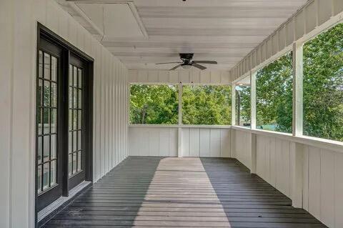 unfurnished sunroom with ceiling fan