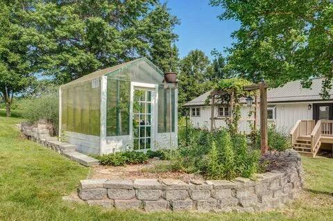 view of greenhouse featuring a lawn