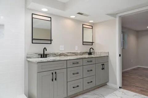 bathroom with double vanity, baseboards, visible vents, marble finish floor, and recessed lighting