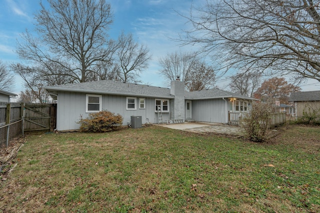 back of property featuring a patio, fence private yard, central air condition unit, a lawn, and a chimney