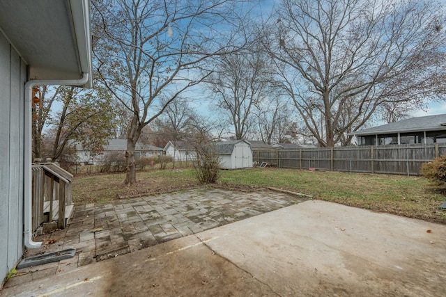 view of patio / terrace featuring a shed, an outdoor structure, and a fenced backyard