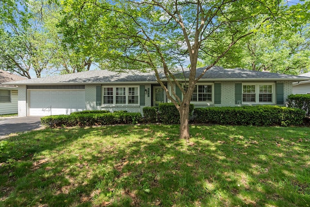 1343 E Greenwood St, Springfield, MO 65804 - ranch-style home with a front yard, an attached garage, aphalt driveway, and brick siding