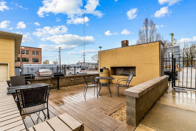 wooden deck with fence and an outdoor fireplace