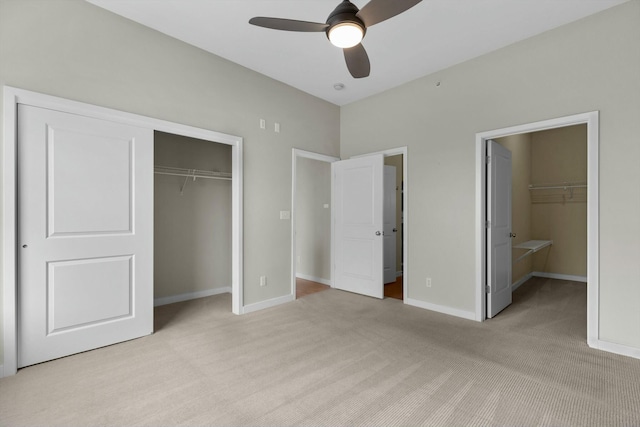 unfurnished bedroom with ceiling fan, a closet, carpet, and baseboards