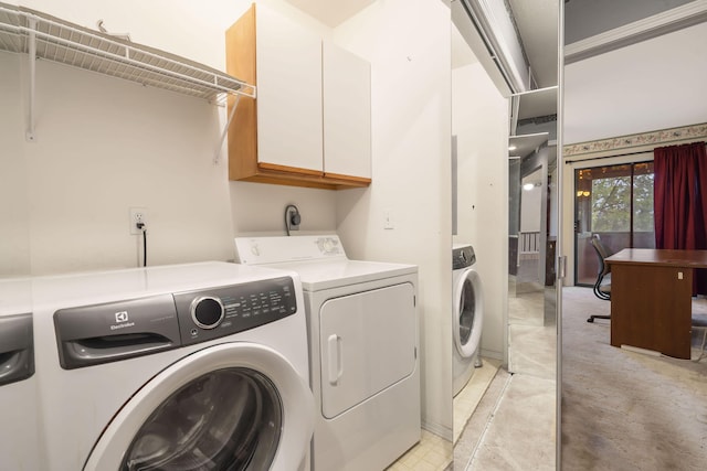 laundry room with cabinet space and washer and clothes dryer