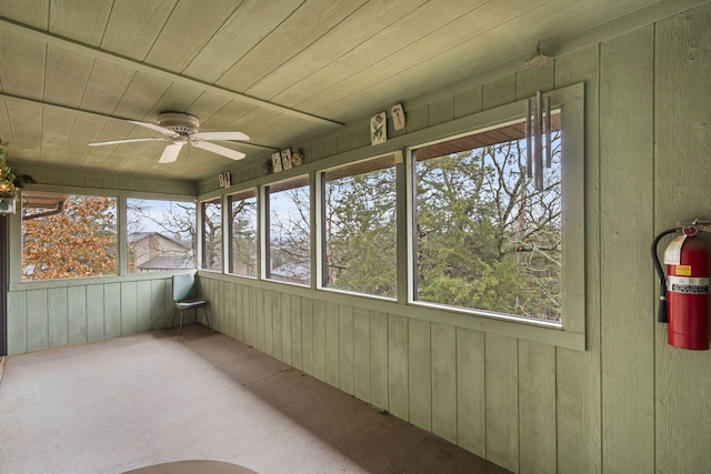 unfurnished sunroom featuring wooden ceiling and ceiling fan