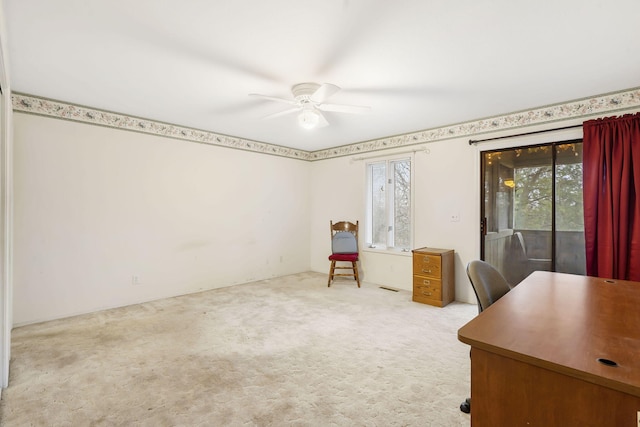 unfurnished office with carpet and ceiling fan