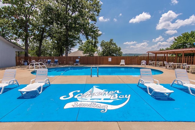 pool featuring fence, a pergola, and a patio