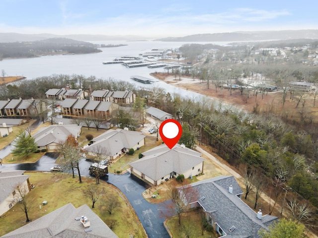 birds eye view of property with a water view and a residential view