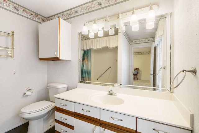 bathroom featuring vanity and toilet