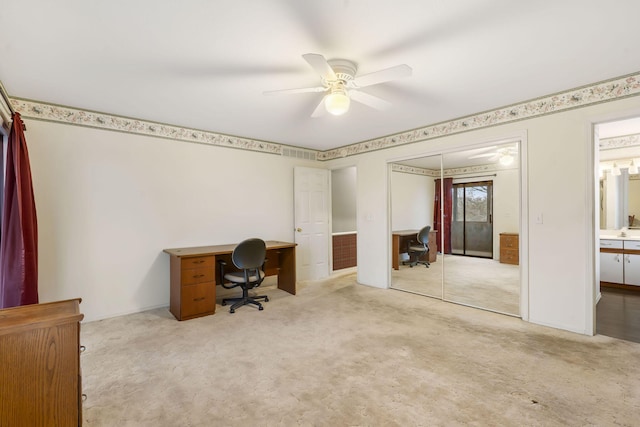 office space featuring ceiling fan, visible vents, and light colored carpet