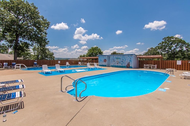 community pool featuring a patio area and fence