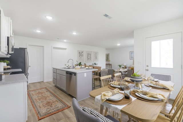 dining room featuring light wood-type flooring, visible vents, and recessed lighting