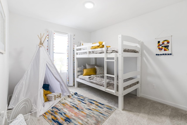 carpeted bedroom featuring baseboards