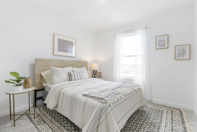 bedroom with baseboards and carpet flooring