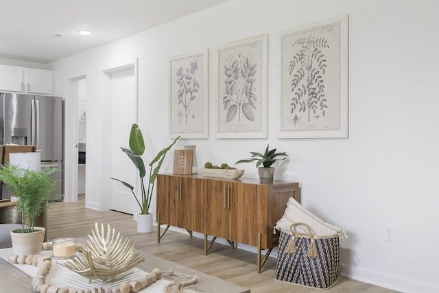 sitting room featuring light wood finished floors and baseboards