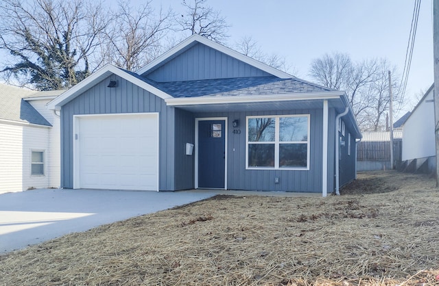 view of front of property with a shingled roof, driveway, and an attached garage