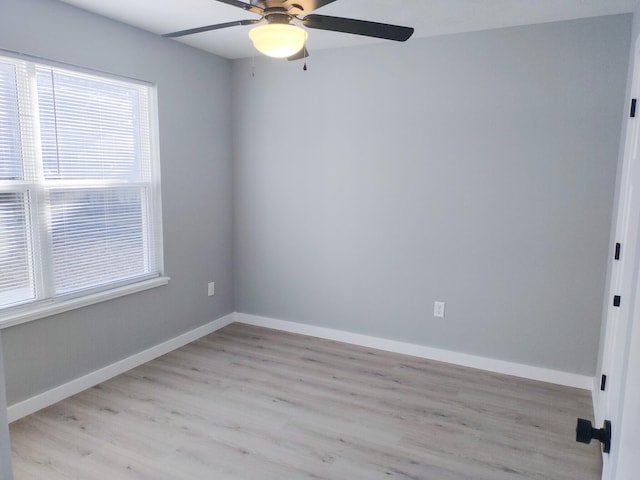 unfurnished room featuring light wood-type flooring, a ceiling fan, and baseboards