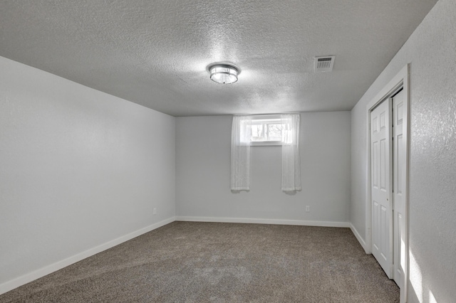 interior space with visible vents, baseboards, and a textured ceiling