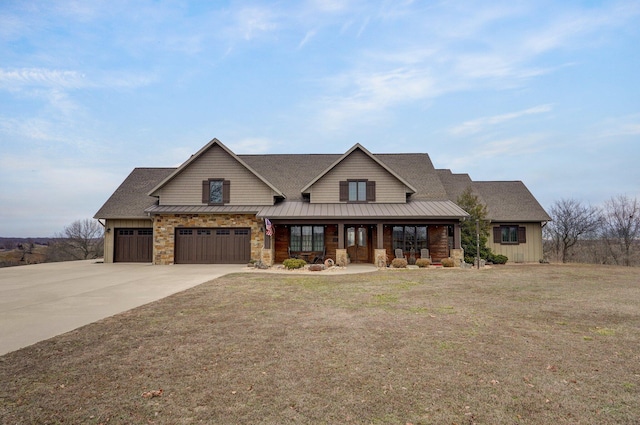 view of front of house with metal roof, concrete driveway, a porch, and a standing seam roof