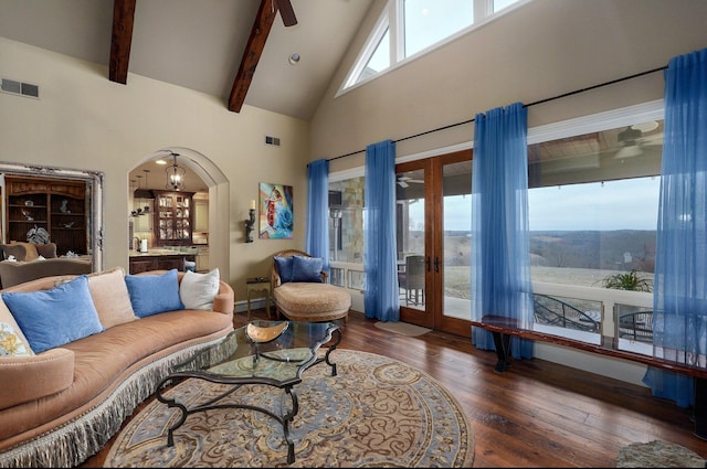 living room with visible vents, arched walkways, wood finished floors, high vaulted ceiling, and beam ceiling