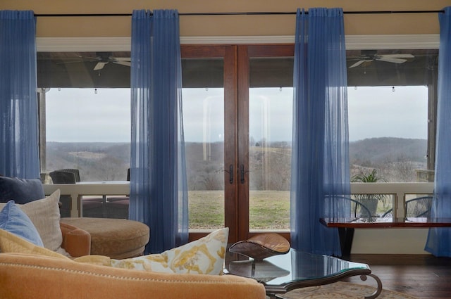 interior space with a ceiling fan and wood finished floors