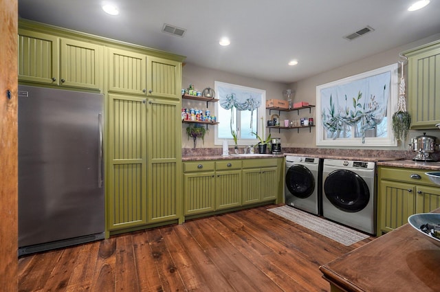 clothes washing area featuring dark wood-style floors, recessed lighting, visible vents, cabinet space, and washing machine and dryer