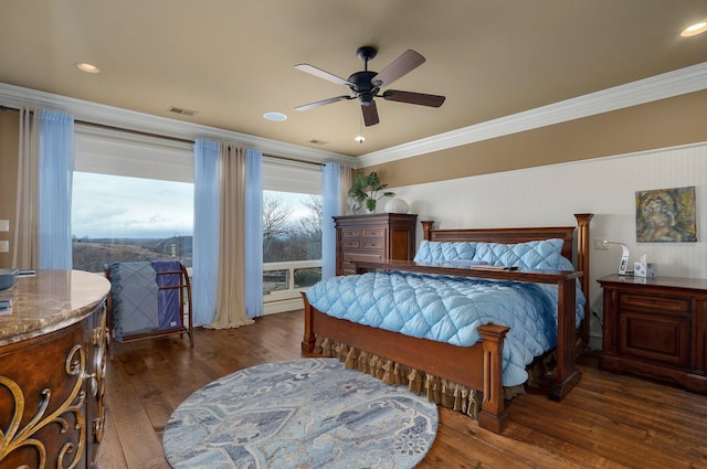 bedroom featuring a ceiling fan, visible vents, dark wood finished floors, and crown molding