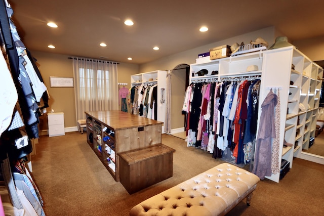 walk in closet featuring carpet flooring