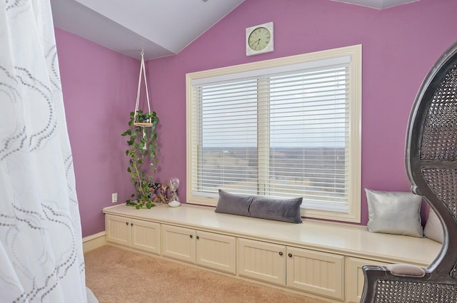 sitting room with lofted ceiling and light colored carpet