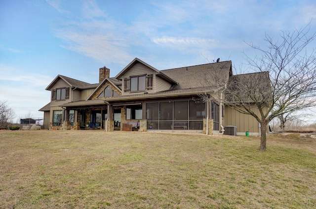 back of house with a lawn, a chimney, cooling unit, and a sunroom