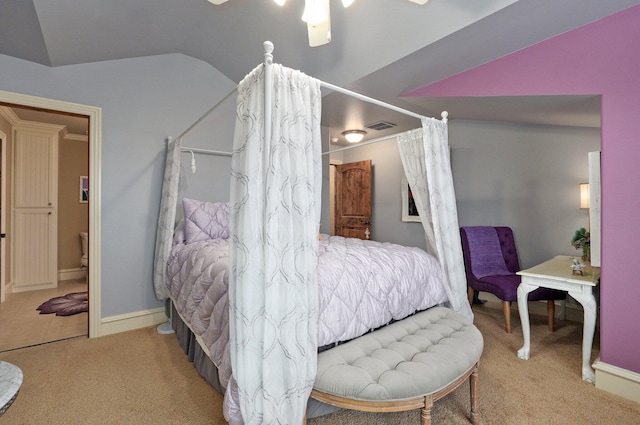 bedroom featuring lofted ceiling, carpet flooring, and visible vents