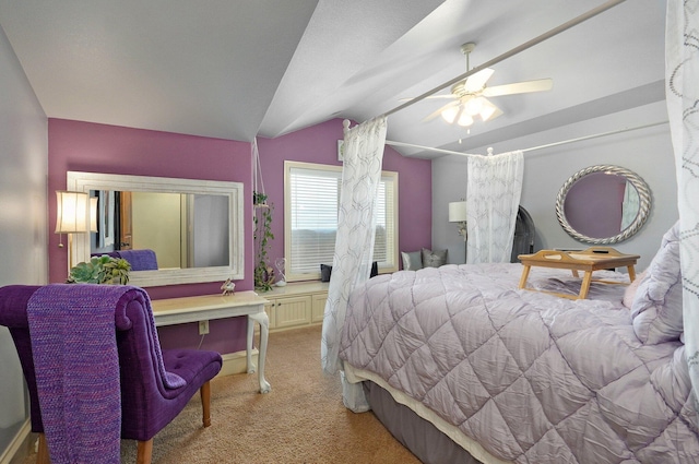 bedroom featuring a ceiling fan, light colored carpet, and vaulted ceiling