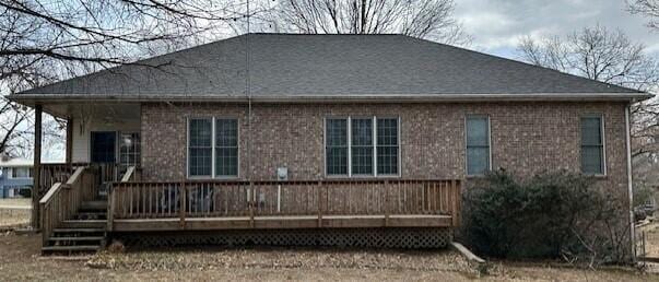 rear view of property featuring a deck