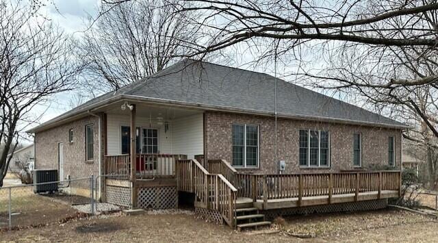 rear view of property featuring fence