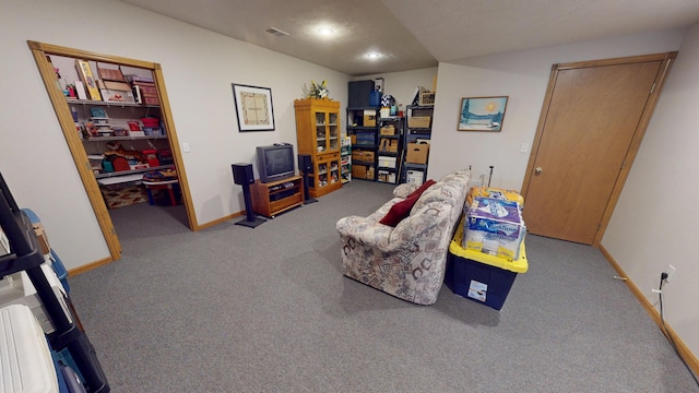 living area with baseboards and carpet flooring