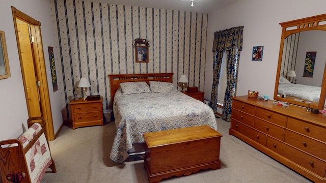 carpeted bedroom with wallpapered walls and arched walkways