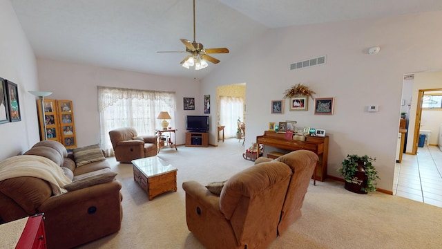 living area with high vaulted ceiling, visible vents, ceiling fan, and light carpet