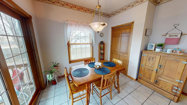 dining room with a wealth of natural light, baseboards, and light tile patterned floors