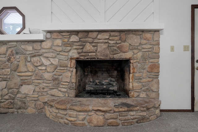 details featuring a stone fireplace, carpet flooring, and baseboards