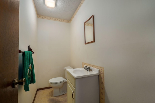 bathroom with toilet, a textured ceiling, and vanity