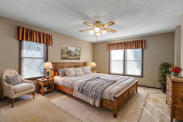 bedroom with ceiling fan and light colored carpet