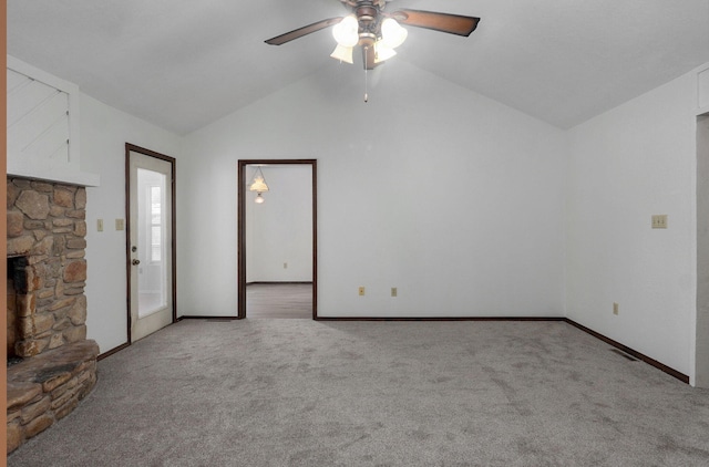 unfurnished living room featuring a fireplace, light colored carpet, vaulted ceiling, ceiling fan, and baseboards