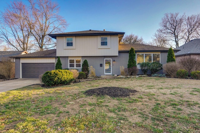 split level home with driveway, brick siding, a front lawn, and an attached garage