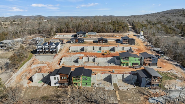 drone / aerial view featuring a mountain view and a forest view